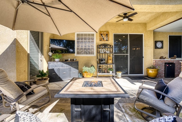 view of patio with an outdoor fire pit and ceiling fan