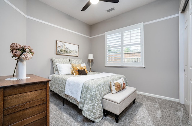 carpeted bedroom with visible vents, ceiling fan, and baseboards