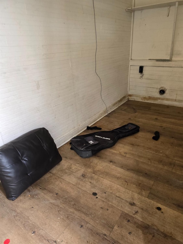 laundry area with wood-type flooring