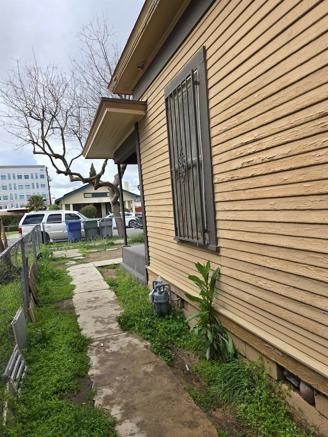 view of home's exterior with fence