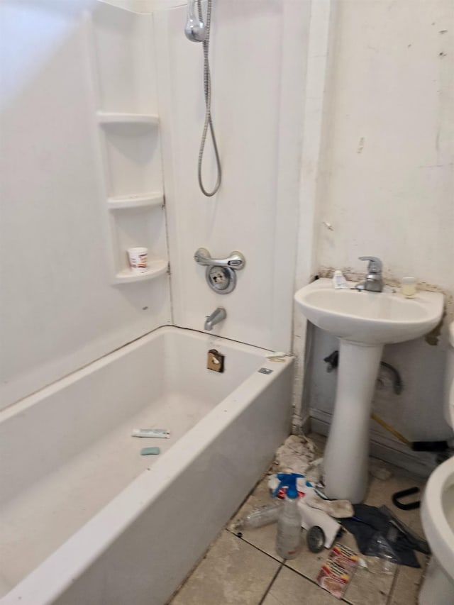 bathroom featuring tile patterned flooring, toilet, and shower / bathtub combination