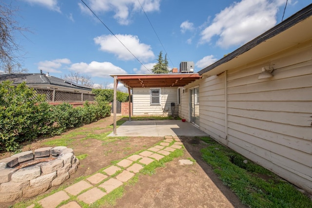 view of yard with a patio area, a fire pit, and fence