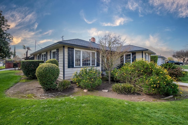 exterior space with a yard and a chimney