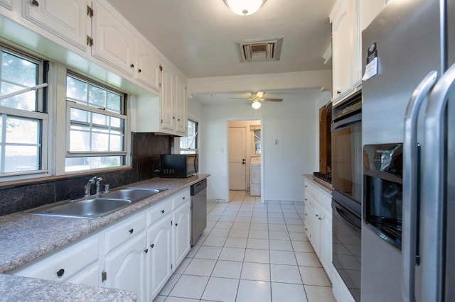 107 W Garland Ave, Fresno, CA 93705 - kitchen featuring black appliances, white cabinetry, washer / dryer, backsplash, and crown molding