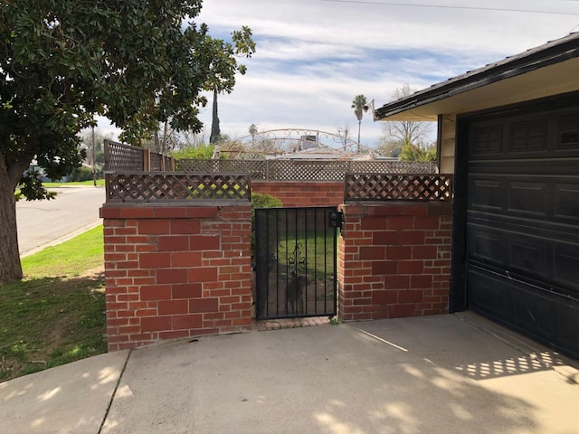 view of gate featuring fence