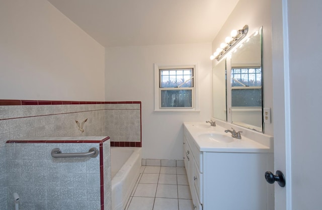 bathroom featuring a sink, a garden tub, double vanity, and tile patterned flooring