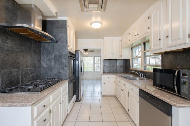 kitchen featuring visible vents, light tile patterned flooring, a sink, black appliances, and island range hood