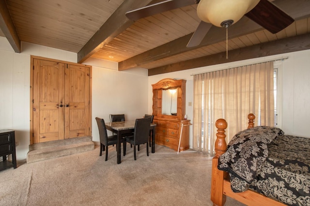 bedroom with ceiling fan, beamed ceiling, wooden ceiling, and carpet flooring