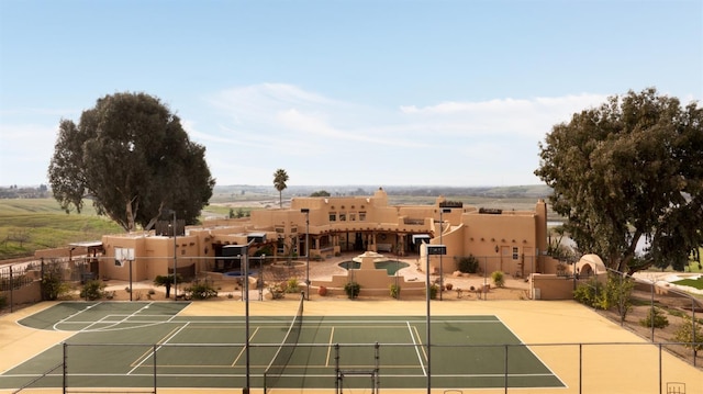 view of tennis court with fence