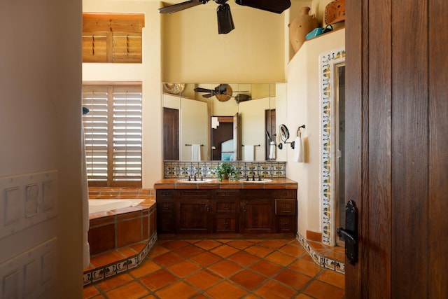 full bath featuring a sink, decorative backsplash, ceiling fan, and a bath