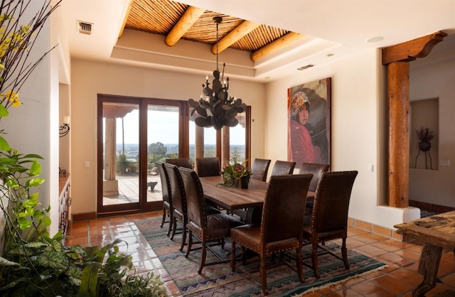 dining area featuring tile patterned flooring, an inviting chandelier, visible vents, and wooden ceiling