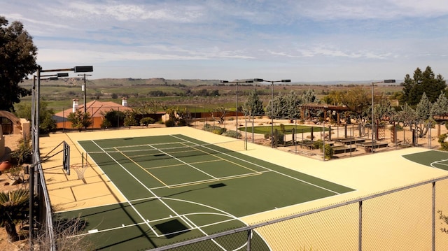 view of sport court featuring fence