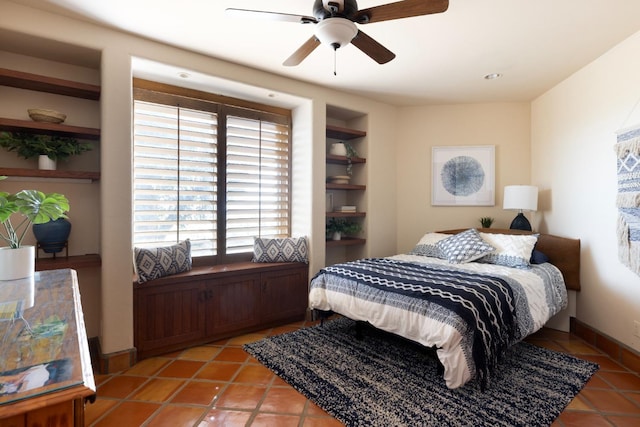 bedroom featuring light tile patterned floors, a ceiling fan, and baseboards