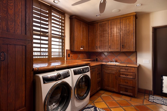 clothes washing area with cabinet space, light tile patterned floors, washing machine and dryer, and ceiling fan