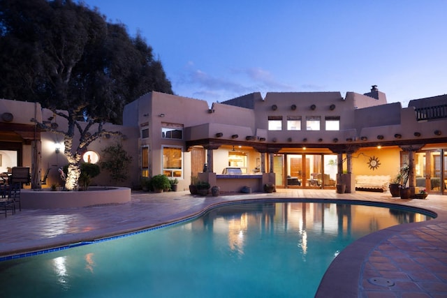 pool with a patio area and a jacuzzi