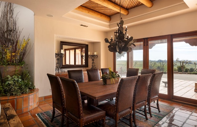 tiled dining space featuring a notable chandelier, visible vents, and a raised ceiling