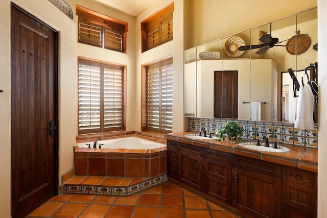 full bathroom featuring a bath, a ceiling fan, tasteful backsplash, and a sink