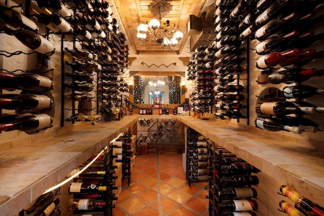 wine cellar with a chandelier and tile patterned floors