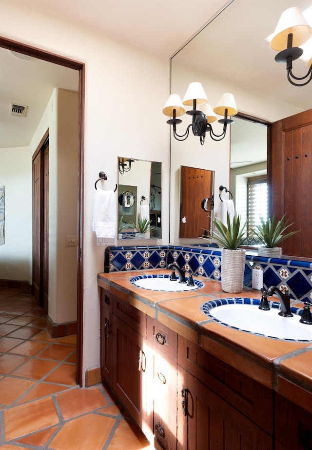 full bath with tile patterned floors, double vanity, visible vents, and a sink