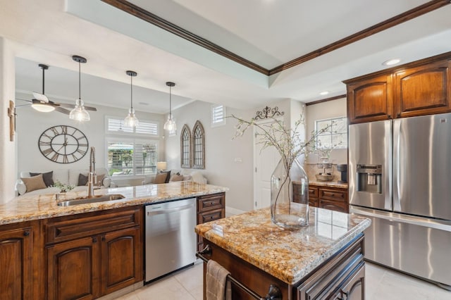 kitchen with light stone counters, appliances with stainless steel finishes, crown molding, and a sink