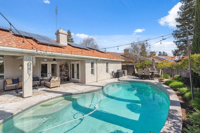 view of pool featuring an outdoor living space, outdoor dining area, a fenced backyard, french doors, and a patio area