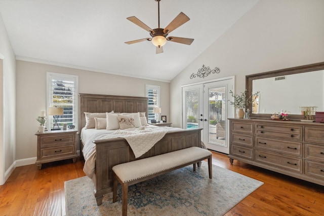 bedroom featuring access to outside, multiple windows, french doors, and light wood finished floors