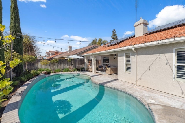 view of swimming pool with an outdoor living space, a fenced in pool, a fenced backyard, a patio area, and a ceiling fan