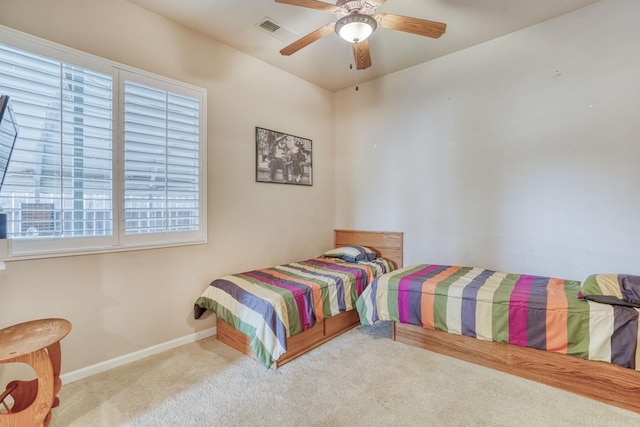 bedroom with a ceiling fan, carpet flooring, baseboards, and visible vents