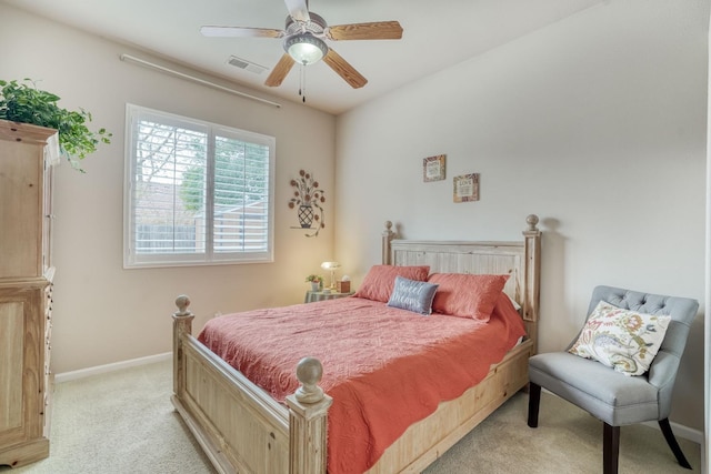 bedroom with visible vents, baseboards, light colored carpet, and ceiling fan