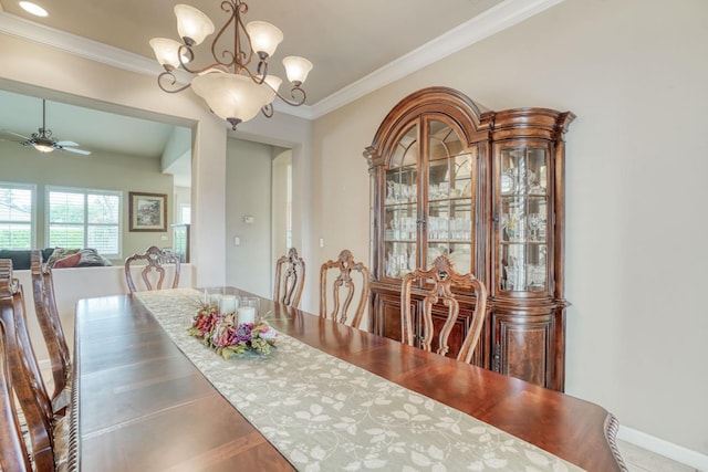 dining space with ceiling fan with notable chandelier, baseboards, and ornamental molding