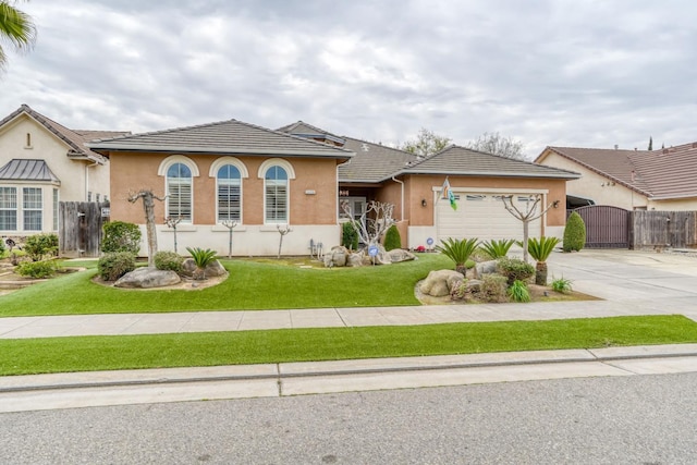 view of front of home featuring a gate, a garage, driveway, and stucco siding