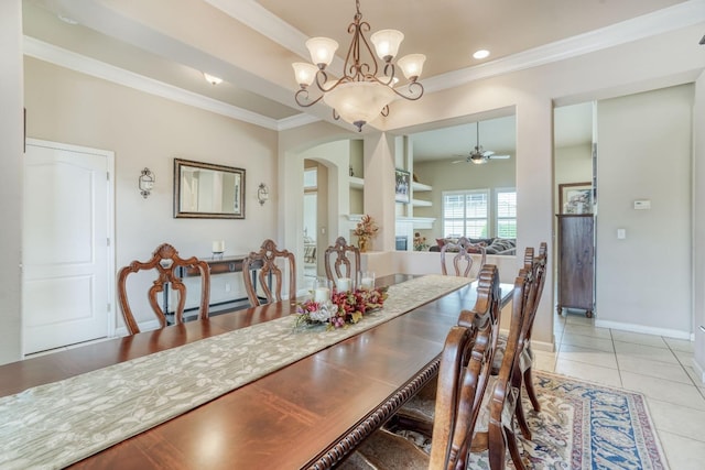 dining area featuring light tile patterned floors, baseboards, arched walkways, ornamental molding, and ceiling fan with notable chandelier