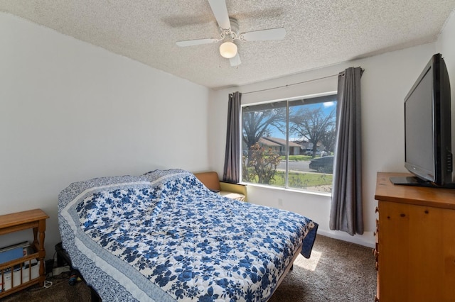 carpeted bedroom with a textured ceiling and a ceiling fan