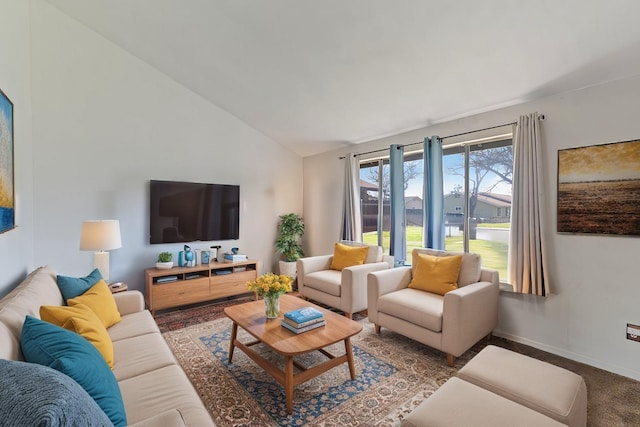 carpeted living room featuring baseboards and vaulted ceiling