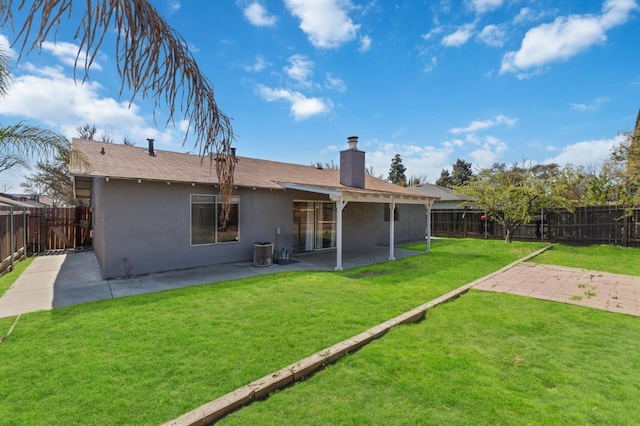 rear view of property featuring a patio area, stucco siding, a lawn, and a fenced backyard