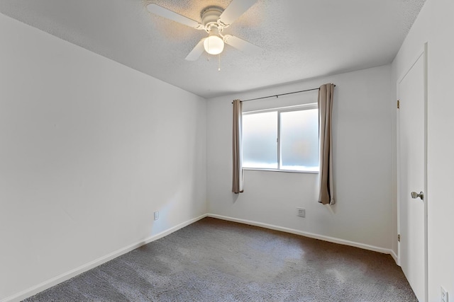 spare room with baseboards, carpet, ceiling fan, and a textured ceiling