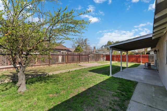 view of yard with a patio, central AC unit, and a fenced backyard