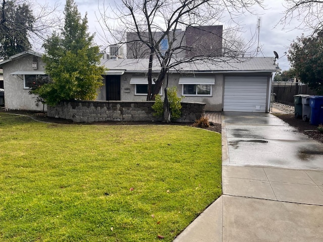 ranch-style house featuring stucco siding, fence, concrete driveway, an attached garage, and a front yard