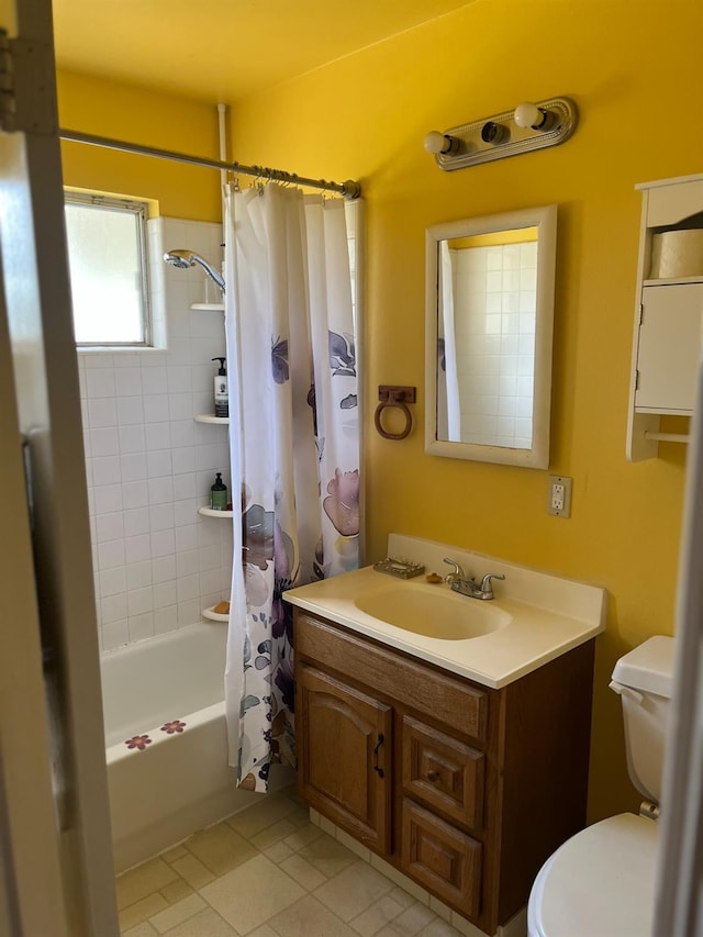 bathroom with shower / bath combo with shower curtain, toilet, vanity, and tile patterned flooring