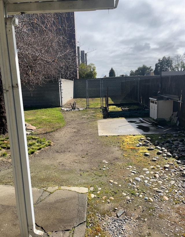 view of yard with fence and a gate