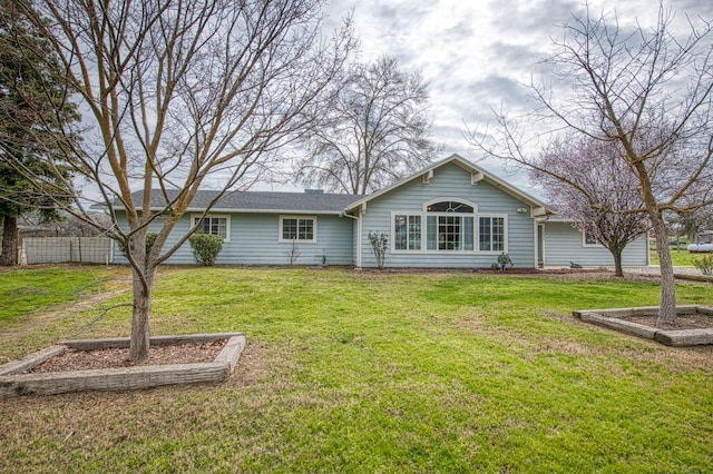 back of house featuring a yard and fence