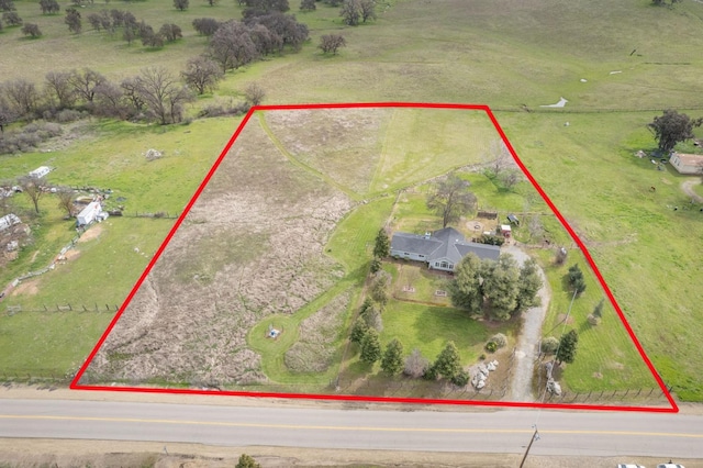 birds eye view of property with a rural view