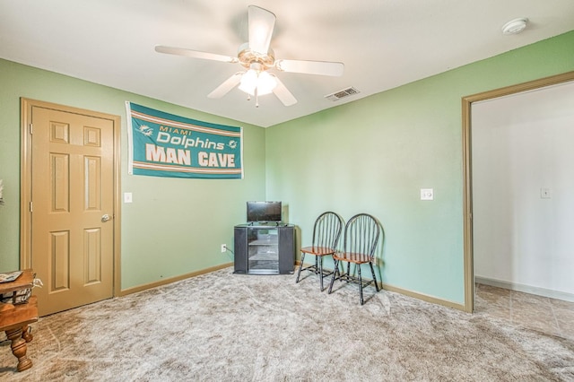 sitting room with carpet flooring, baseboards, visible vents, and ceiling fan