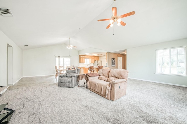 living area with baseboards, visible vents, carpet floors, lofted ceiling, and ceiling fan