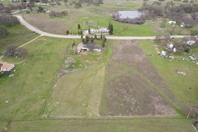 birds eye view of property with a water view and a rural view