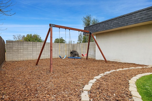 view of playground with a fenced backyard