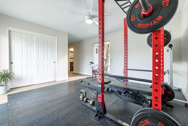 exercise room with baseboards and a ceiling fan