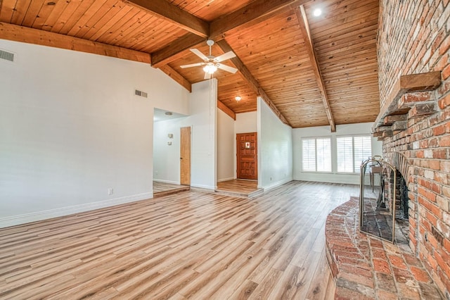 unfurnished living room with beamed ceiling, baseboards, wood ceiling, and wood finished floors