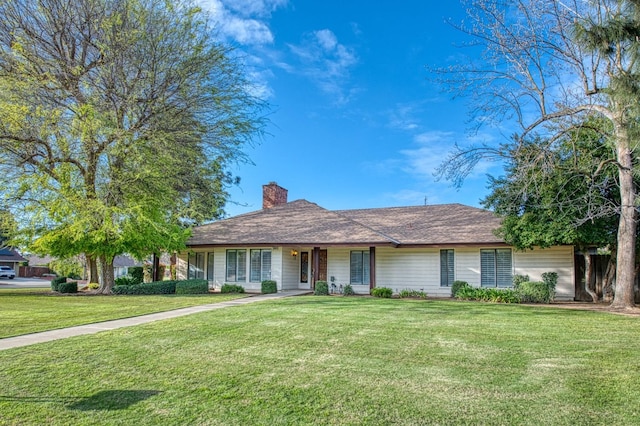 ranch-style house with a front lawn and a chimney