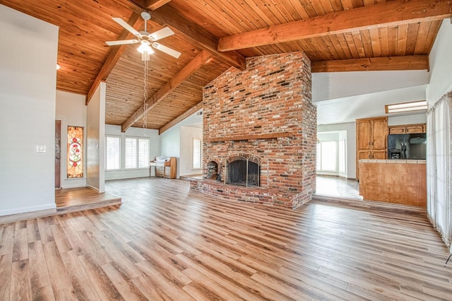 unfurnished living room with beamed ceiling, light wood-style flooring, wooden ceiling, high vaulted ceiling, and a ceiling fan